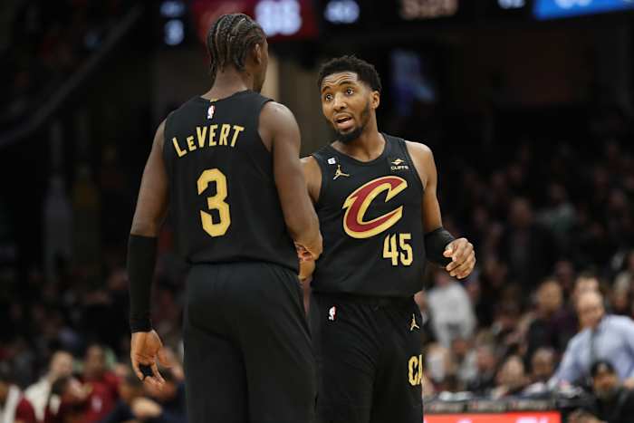 Dec 17, 2022; Cleveland, Ohio, USA; Cleveland Cavaliers guard Donovan Mitchell (45) talks with guard Caris LeVert (3) in the second half against the Dallas Mavericks at Rocket Mortgage FieldHouse. Mandatory Credit: Aaron Josefczyk-USA TODAY Sports